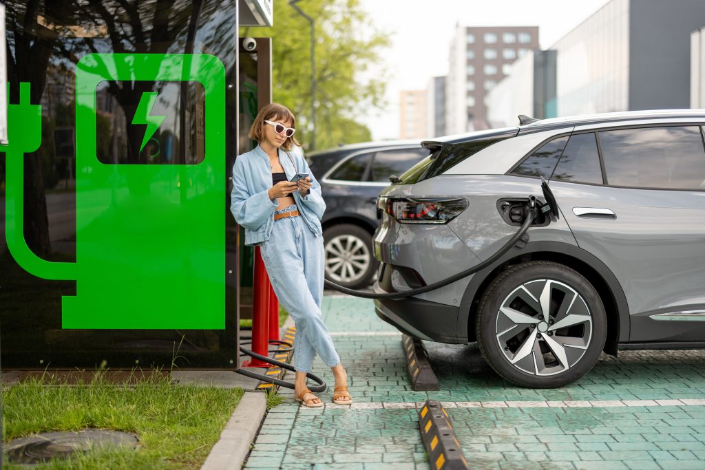 Charging battery of an electric car in city.